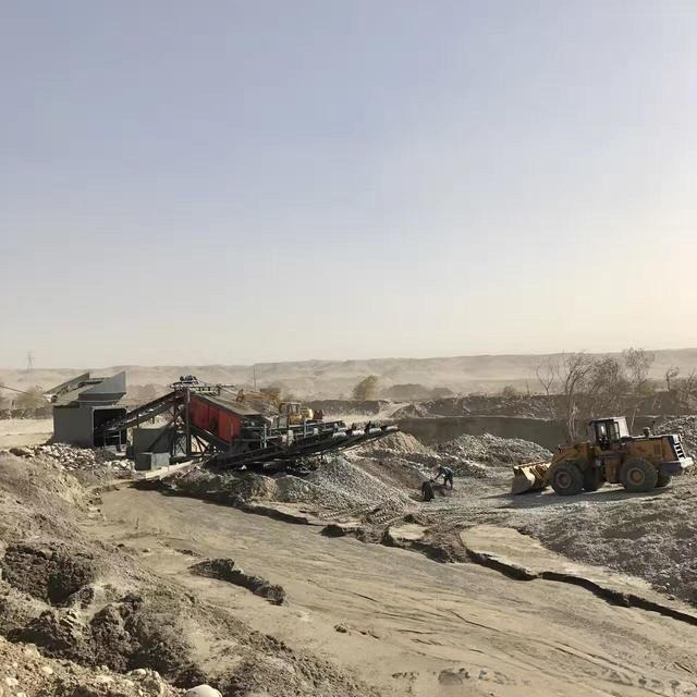 Excavated and scarred riverbed of the Yurungkash showing environmental impact.