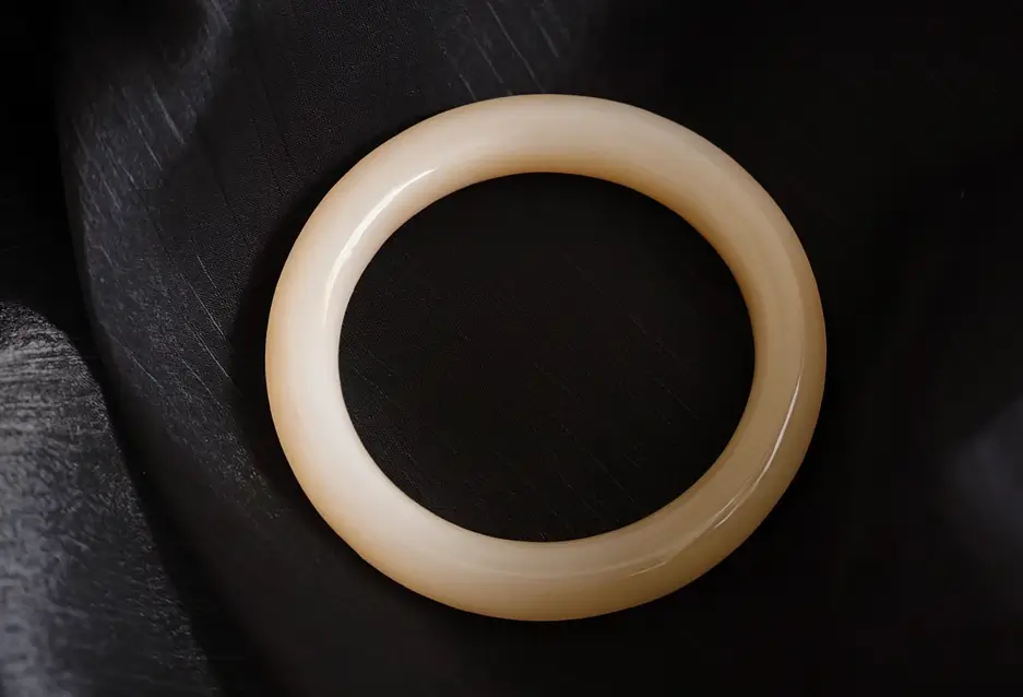 Close-up of a high-quality Lotus Root Pink Nephrite Jade bangle with fine texture and deep pink hue.