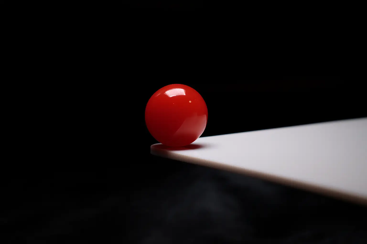 Close-up of a premium Jin Red Southern Red Agate bead against a black background.