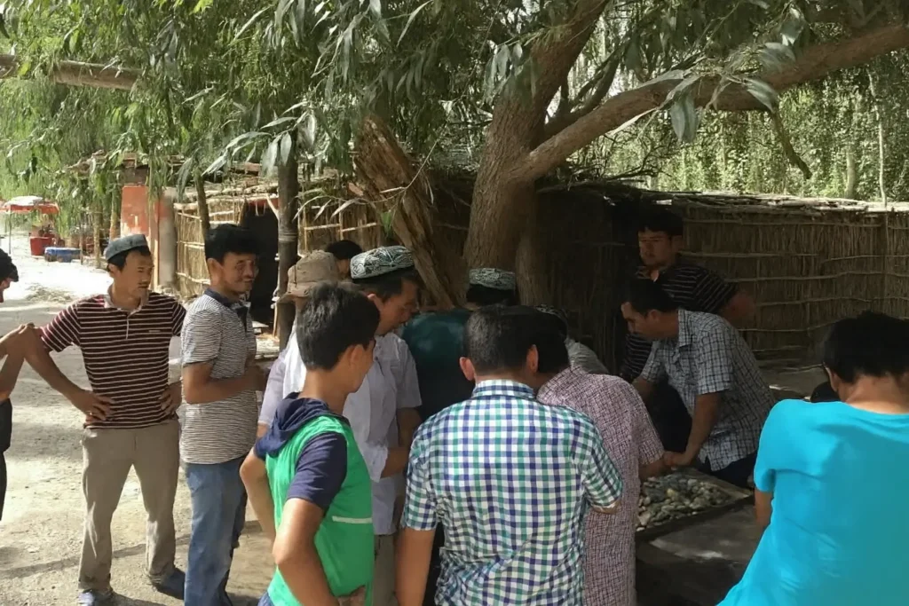 View of the small, informal Mariyan trading spot in Xinjiang, with buyers gathered around jade stalls examining rough stones.