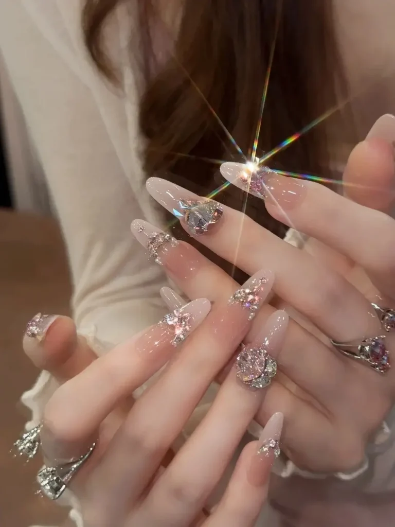 Assorted sizes of glass rhinestones used for nail art, demonstrating low-cost diamond substitutes.