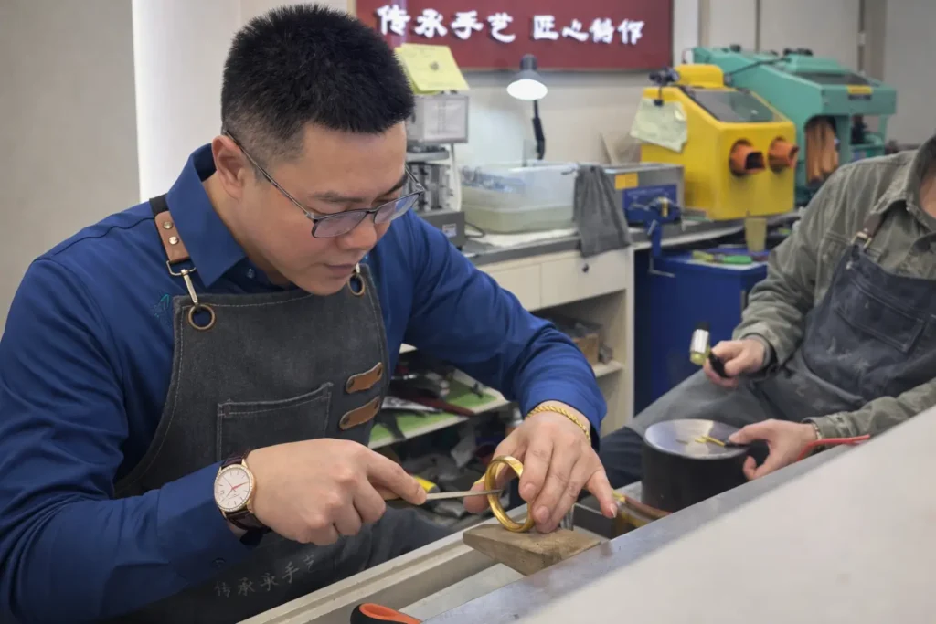 PeonyJewels artisan weighing gold to prevent gold recasting weight loss.