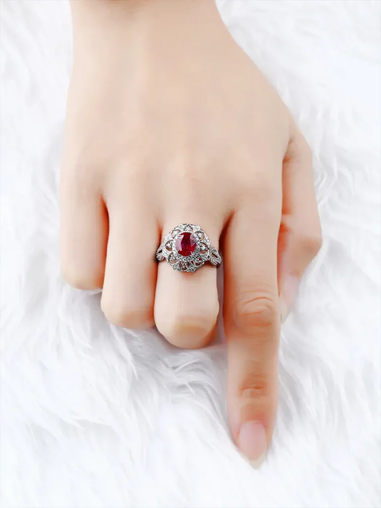 Model wearing a PeonyJewels bespoke 18K gold ring with a natural unheated pigeon blood ruby and diamonds.