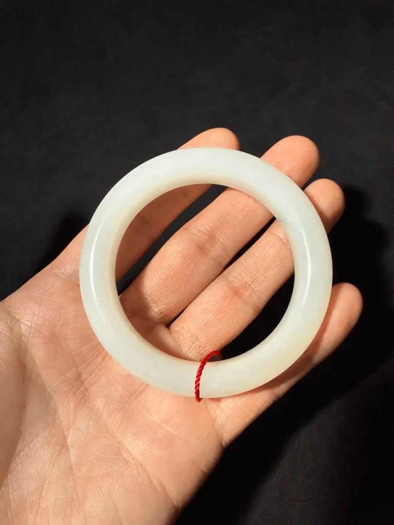 PeonyJewels custom-made Hetian Jade bangle, showcasing fine texture and classic craftsmanship, ready for presentation.