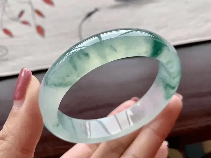 PeonyJewels showcases a custom handcrafted Jadeite bangle with polished translucency and elegant green tones.