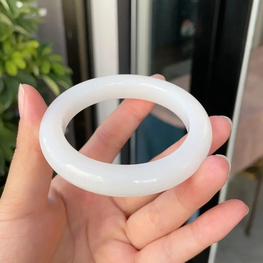 A handcrafted white Mountain Material jade bangle by PeonyJewels.