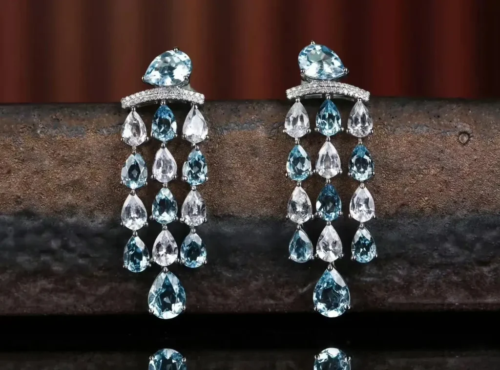 Pair of elegant Peony Jewels earrings featuring clear, colorless white sapphires in a minimalist setting.