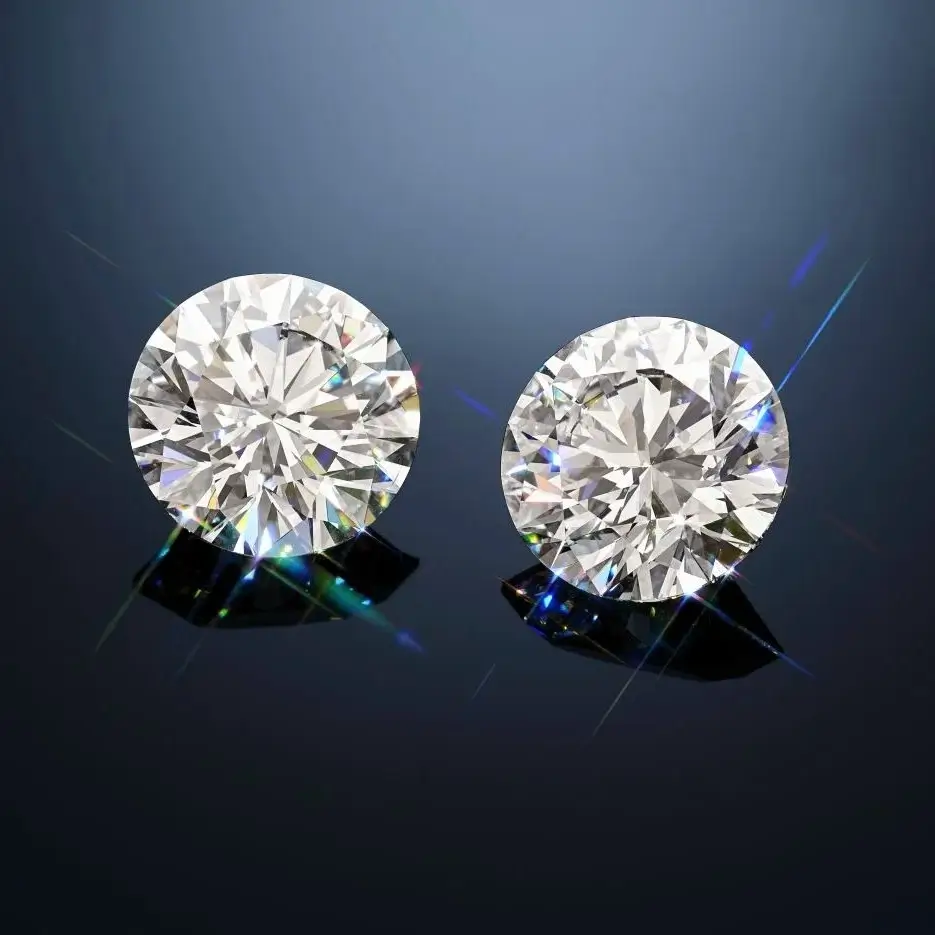 Two perfectly cut round brilliant loose diamonds, showcasing the standard of brilliance and fire used in Moissanite vs Diamond comparison.