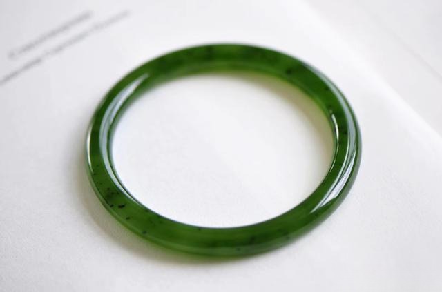 Russian Nephrite Jade bangle with visible natural black chromite spots.