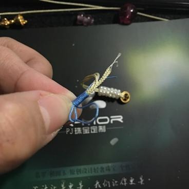 Illustration showing the coiling thread being pulled through the small pre-made loop to secure the entire wrap structure.