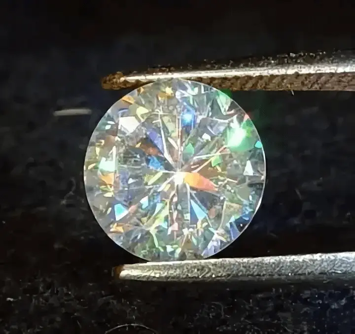 A faceted Strontium Titanate stone displaying unnatural and extreme rainbow fire.