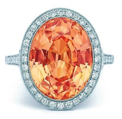 Tiffany & Co. platinum ring featuring a rare 11.15ct vivid orange sapphire and diamond side stones.