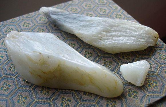 A piece of Alluvial Jade with partially rounded edges and smooth surface.