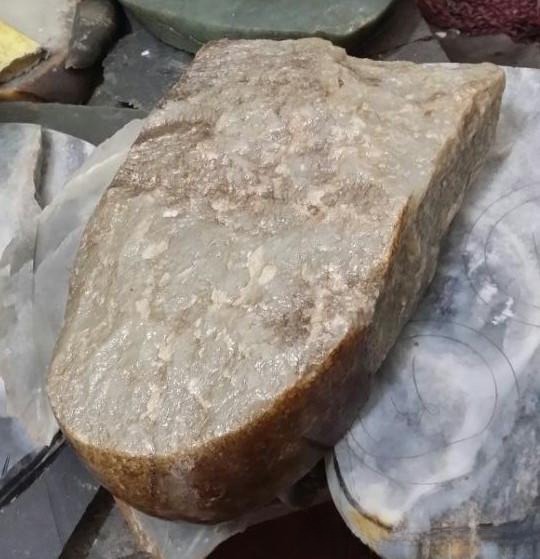 A weathered Hetian Gobi Jade with distinctive wind-eroded surface pits.