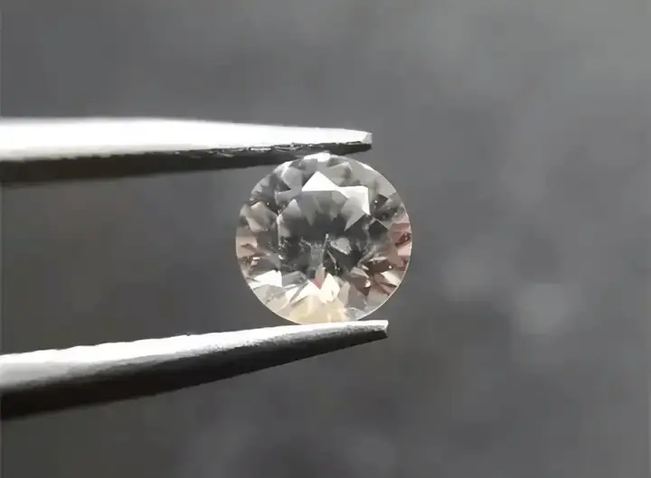 A faceted Yttrium Aluminum Garnet (YAG) gemstone, an older diamond simulant known for its low fire