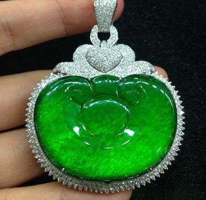 A thin-mounted Yongchu jade pendant designed to enhance color through hollow-backed setting.