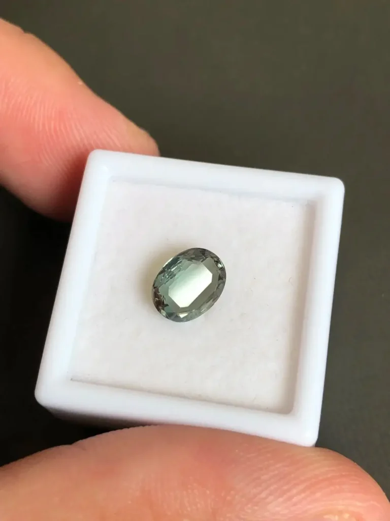 A nearly 1.5-carat natural Alexandrite accompanied by a GUILD gemstone laboratory report.