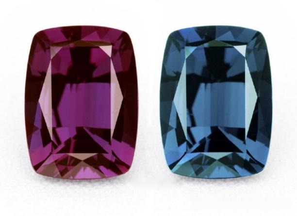 Two Alexandrite gems showing vivid green in daylight and deep raspberry red under incandescent light.