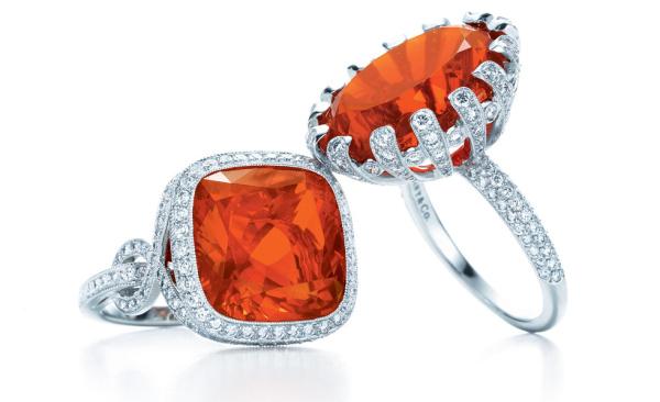 Opal Buying Guide: Pair of fire opal rings with vibrant flowing play-of-color and bold visual presence.