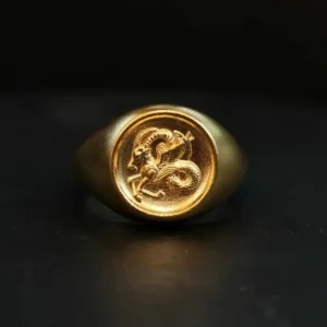 Front view of solid gold Capricorn signet ring with engraved sea-goat symbol