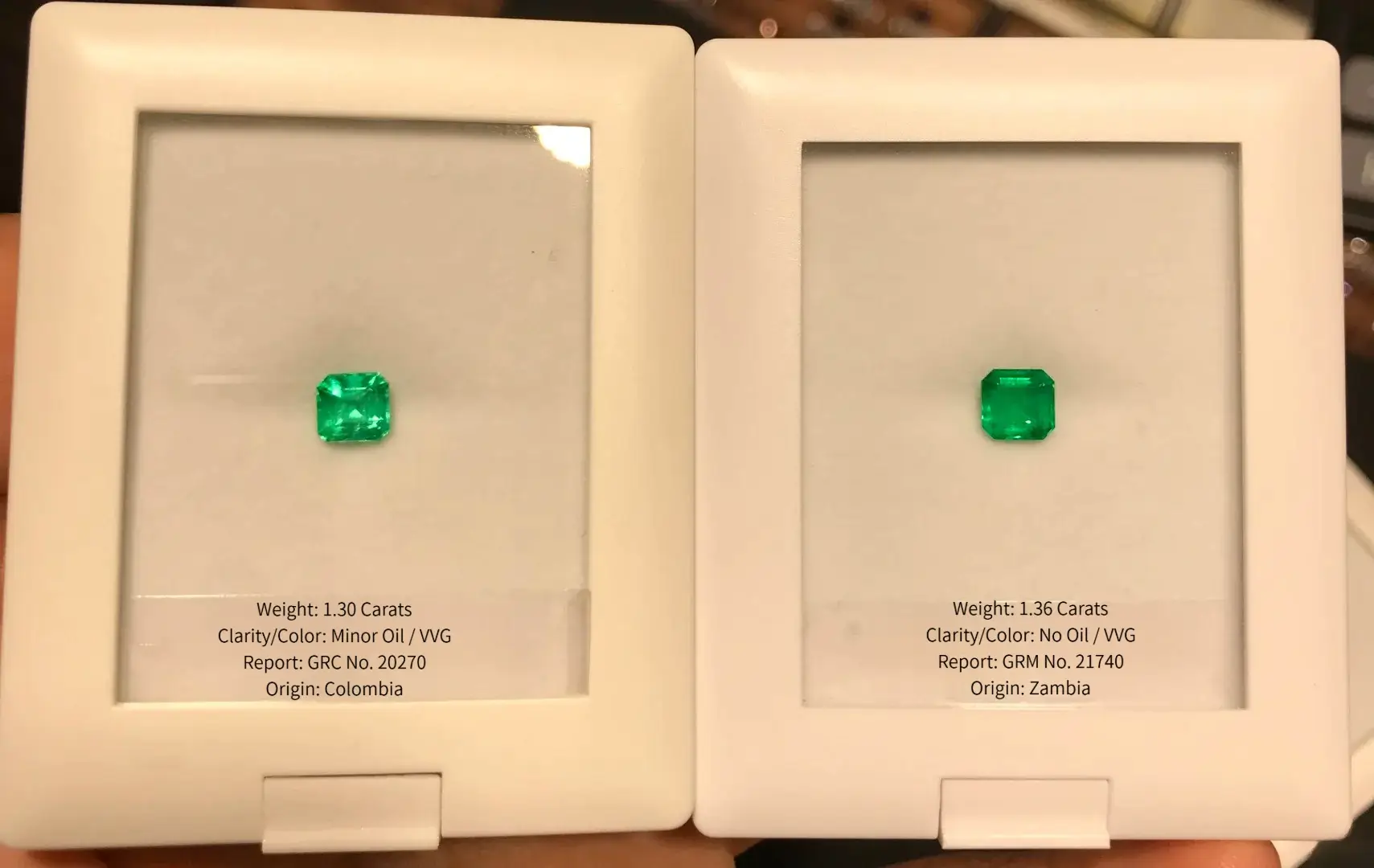Comparison of 1.30ct Colombian Minor Oil and 1.36ct Zambian No Oil VVG emeralds side by side.