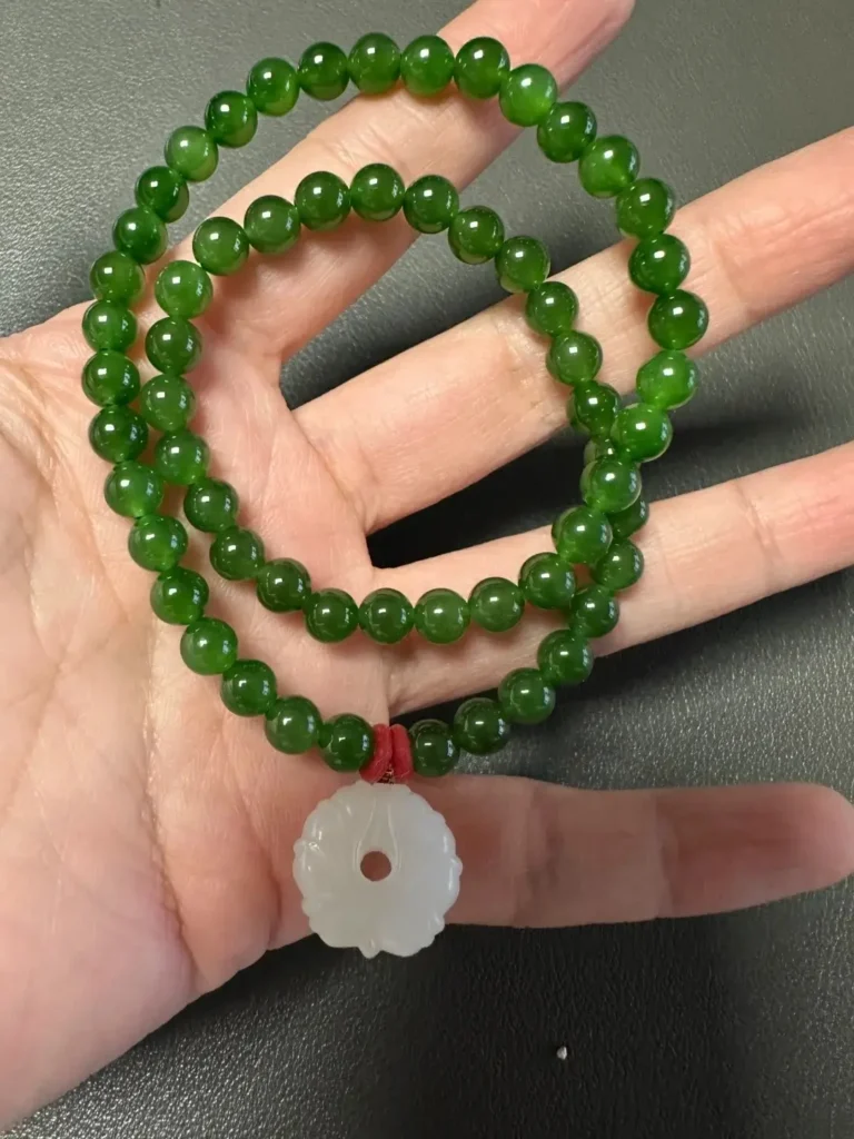 Multi-wrap Russian nephrite bead strand from Eastern Sayan, worn stacked on the wrist.