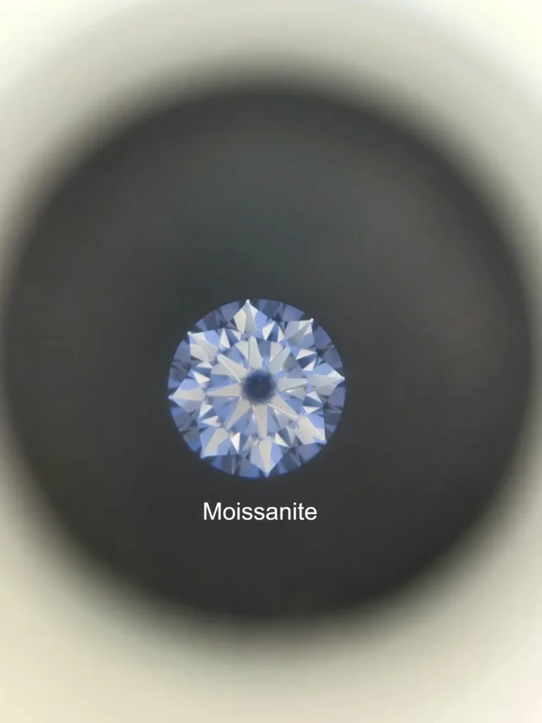 A microscope view showing the smooth, consistent polishing lines on the facets of a high-quality moissanite gemstone.