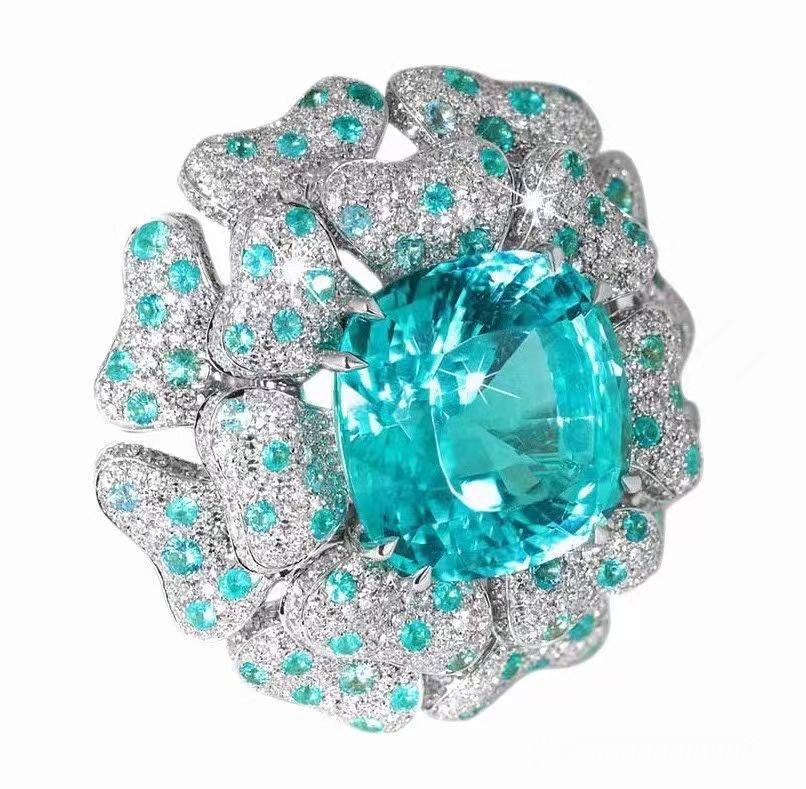Paraiba tourmaline ring showing vivid blue-green gemstone set in polished metal band, highlighting brilliance.
