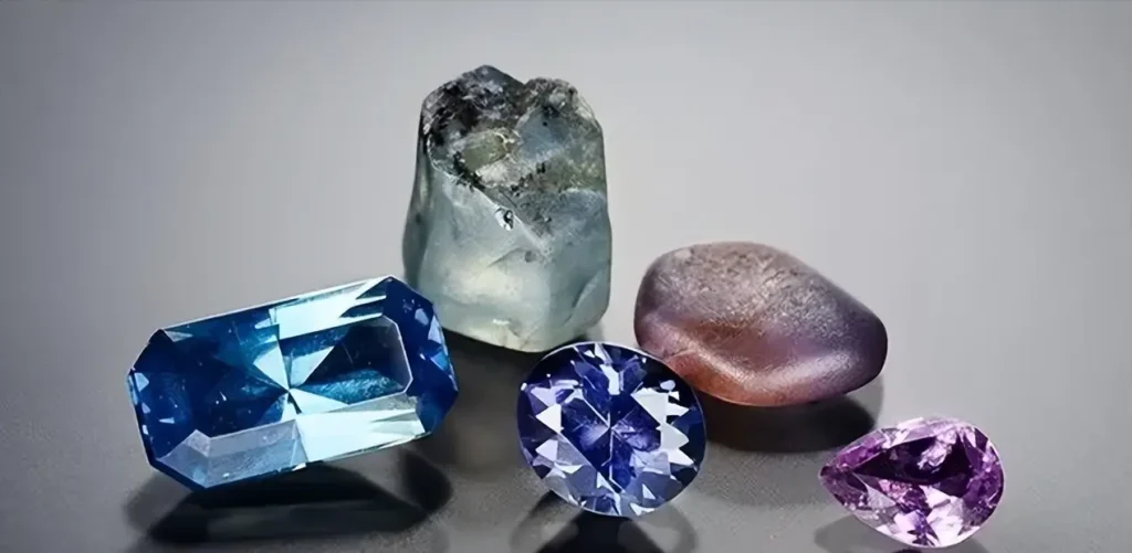 Faceted and raw Colombian sapphires displaying rare pink and purple hues from the Mercaderes region.