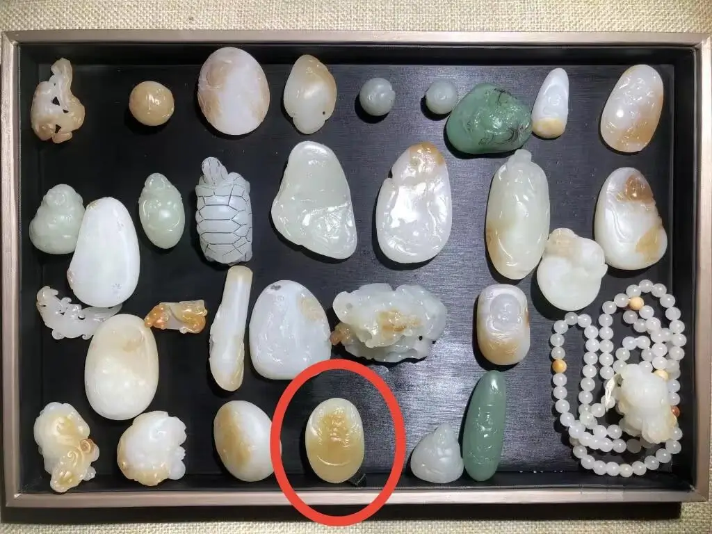 Batch of premium Qiemo sugar-white jade pendants from the same source.