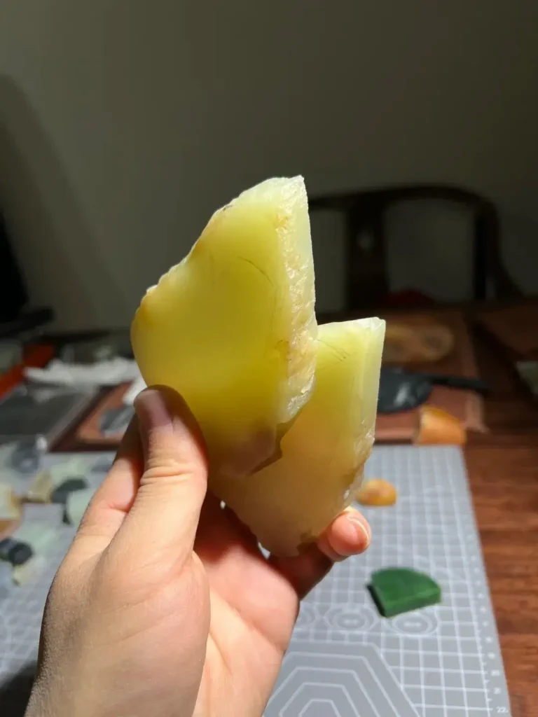 A sliced section of true primary yellow Hetian jade showing consistent internal color.