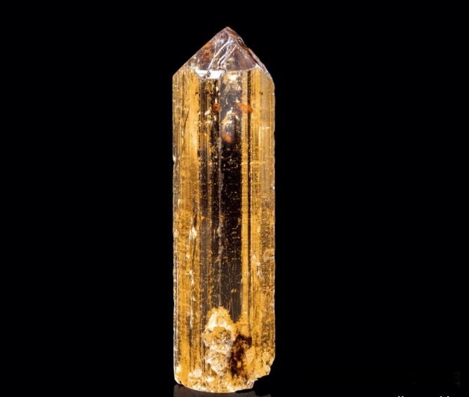 Raw prismatic Topaz crystal showing natural orthorhombic structure and vitreous luster.