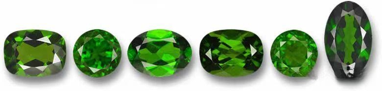 Various green shades of Russian chromium diopside gemstones displayed, showing color range and transparency.
