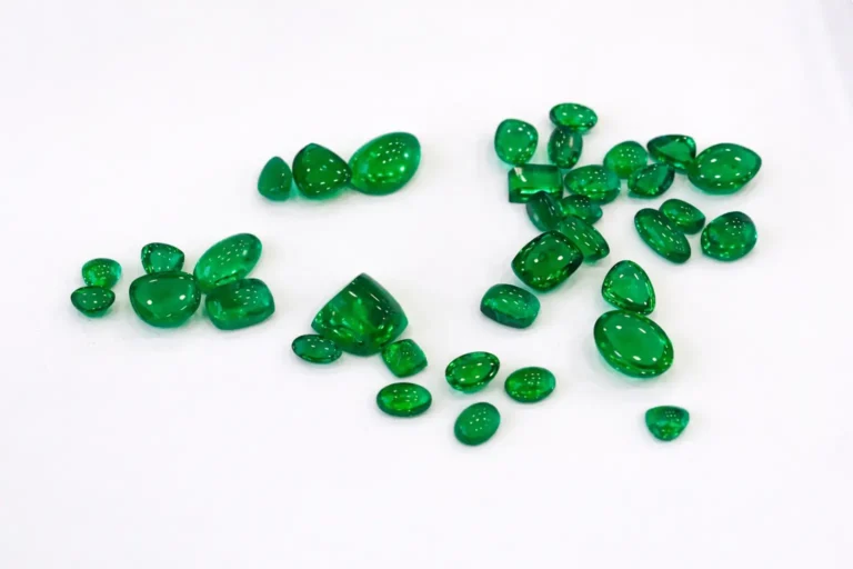 A batch of clean Russian emeralds, ranging from 1 to 10 carats, displaying a neon-like glow.