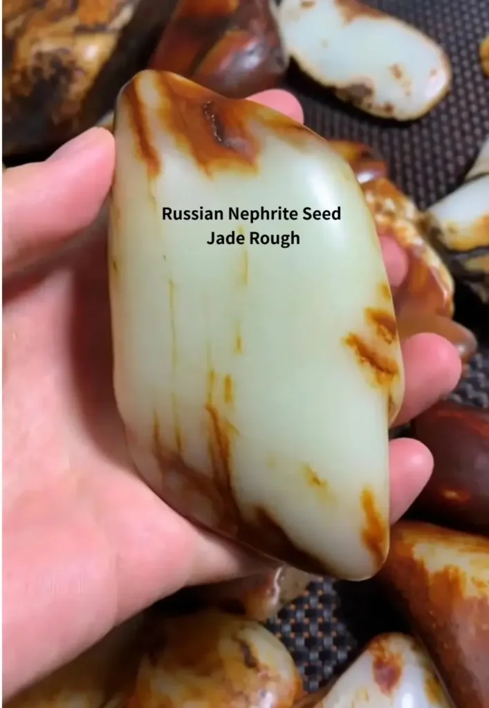 A Russian seed jade stone with a thick weathered skin and characteristic bone-white internal flesh.
