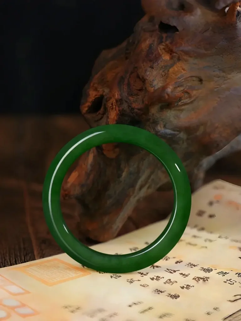 A vibrant spinach green Hetian Bi Yu jade bangle with rich chromium-driven coloration.