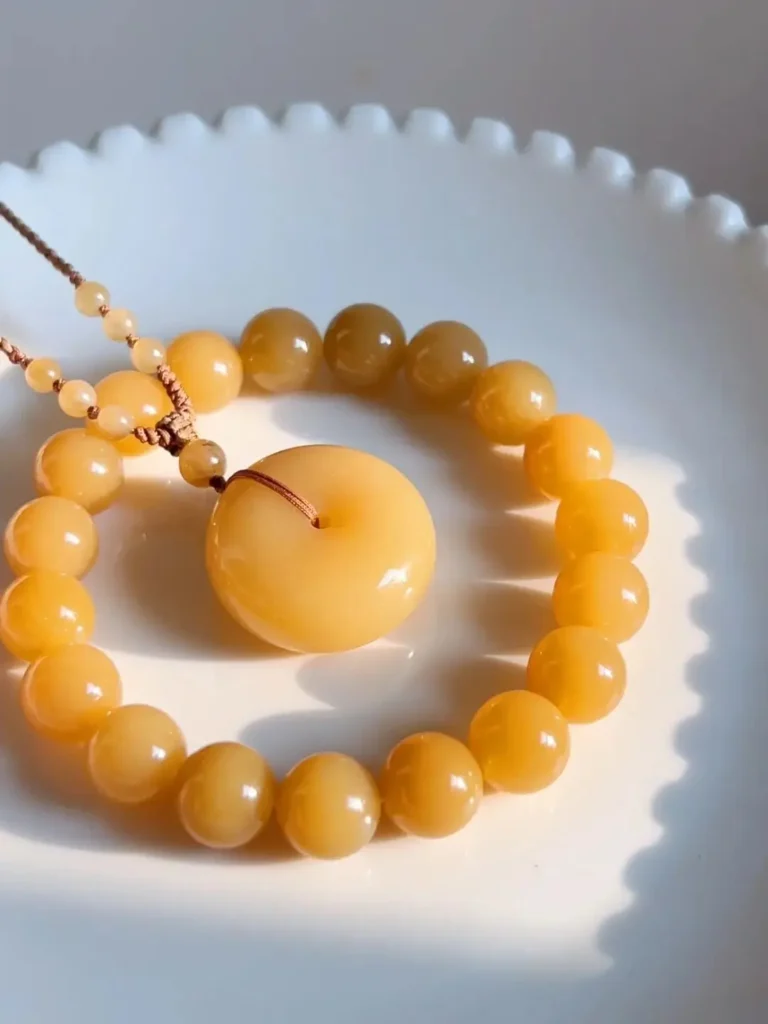 Premium Hetian Jade bracelet and pendant being carefully displayed.