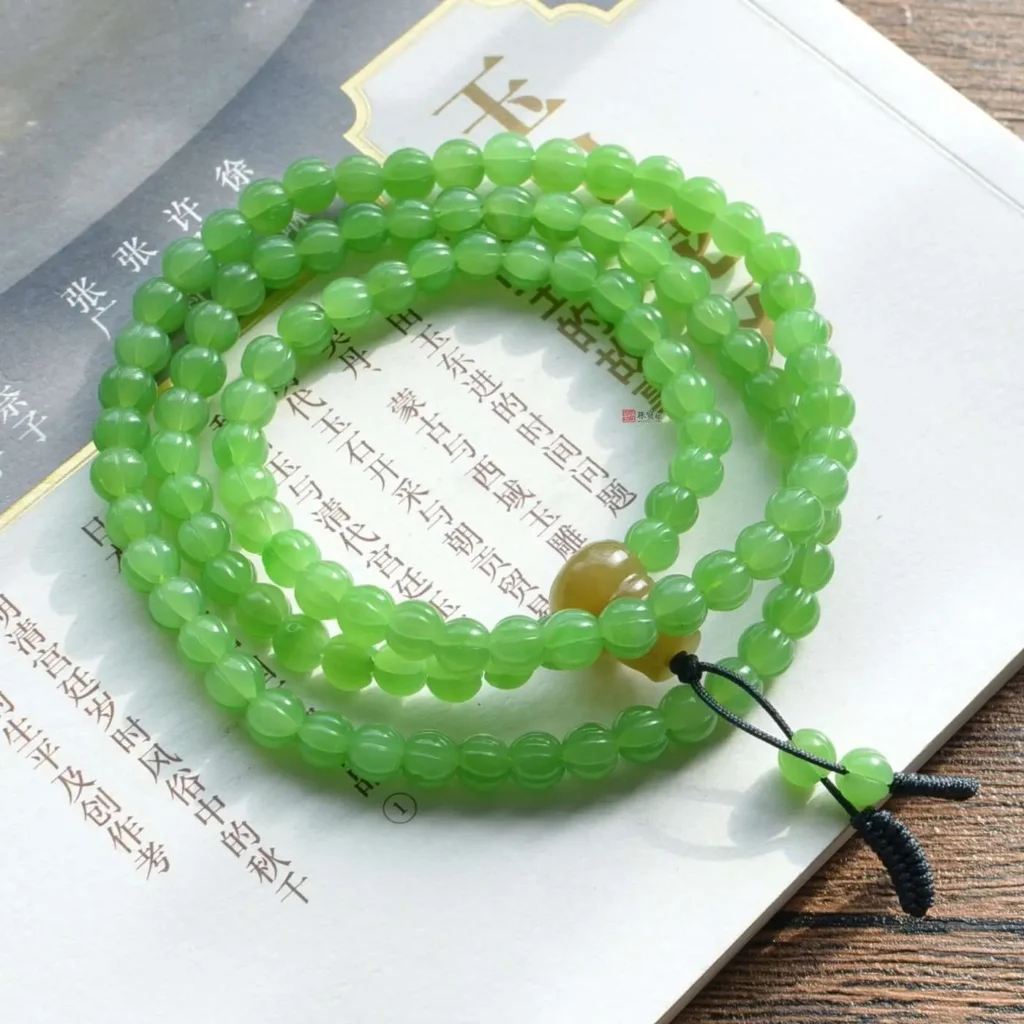 Ulan-Hada nephrite necklace featuring fresh apple green tones and fine, dispersed black inclusions.