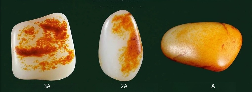 Comparison of Xinjiang seed jade stones showing top collector, premium, and quality grades.